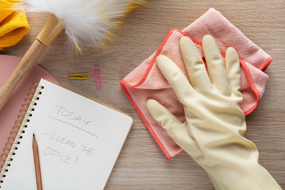 home cleaning checklist on paper with supplies